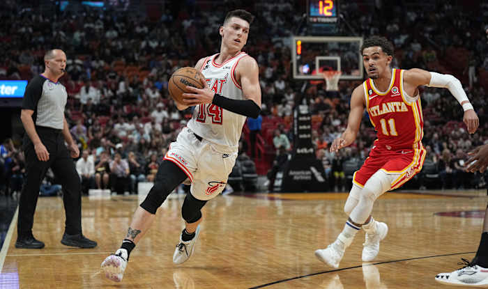 Miami Heat guard Tyler Herro drives past Atlanta Hawks guard Trae Young.